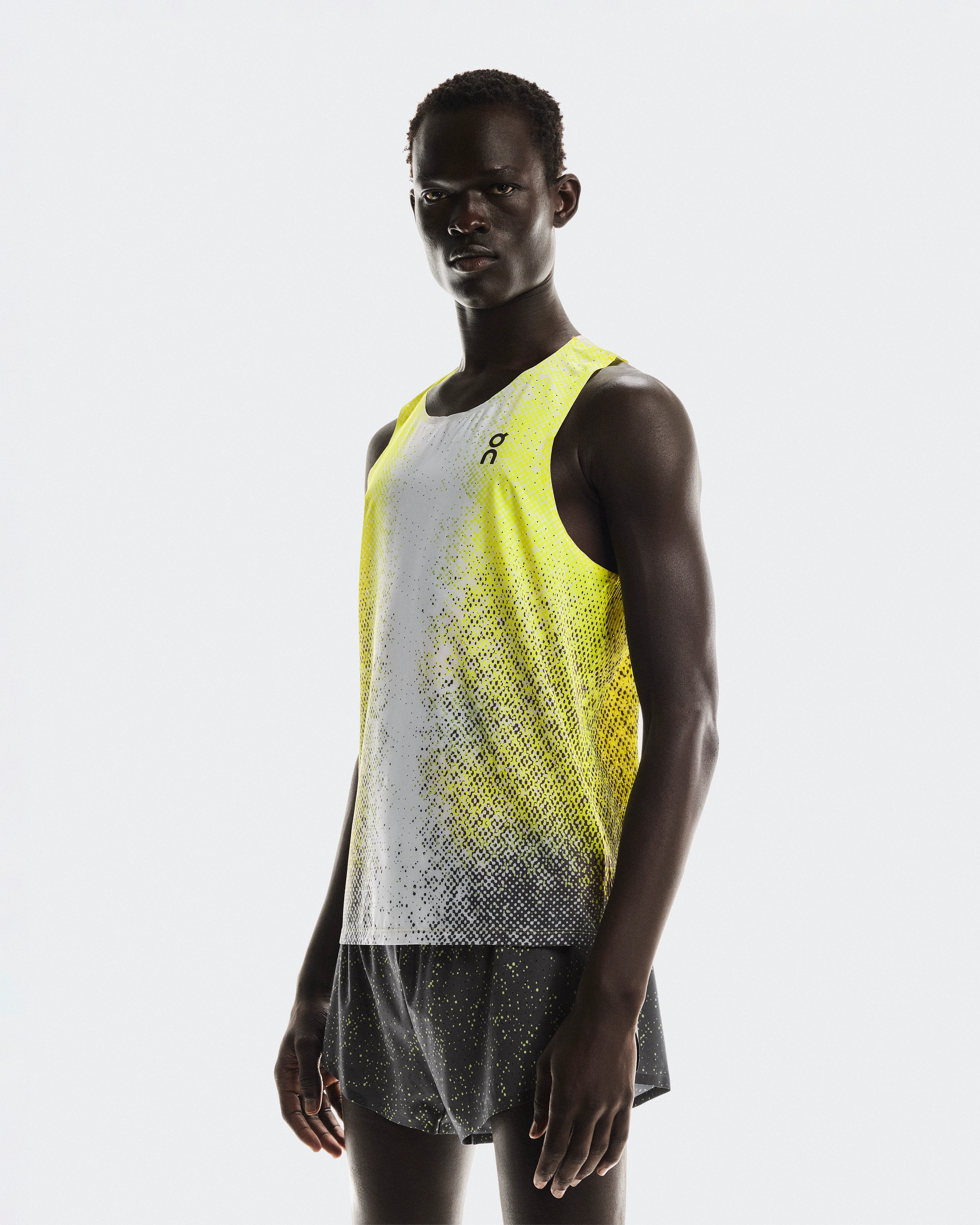 A male athlete wearing On workout gear, staring seriously at the camera.