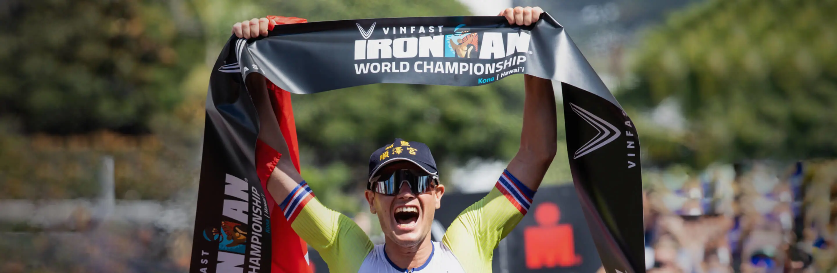 Gustav Iden holds the ironman championship banner