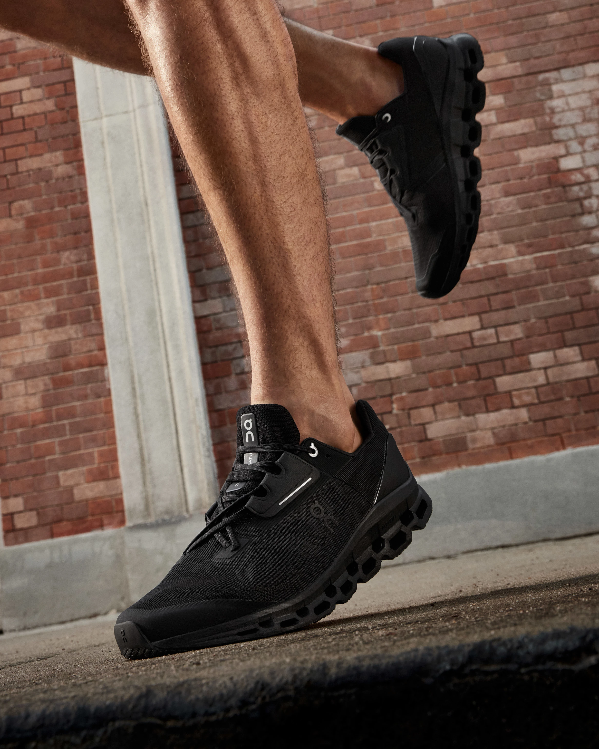 A closeup of a shoe with a brick background