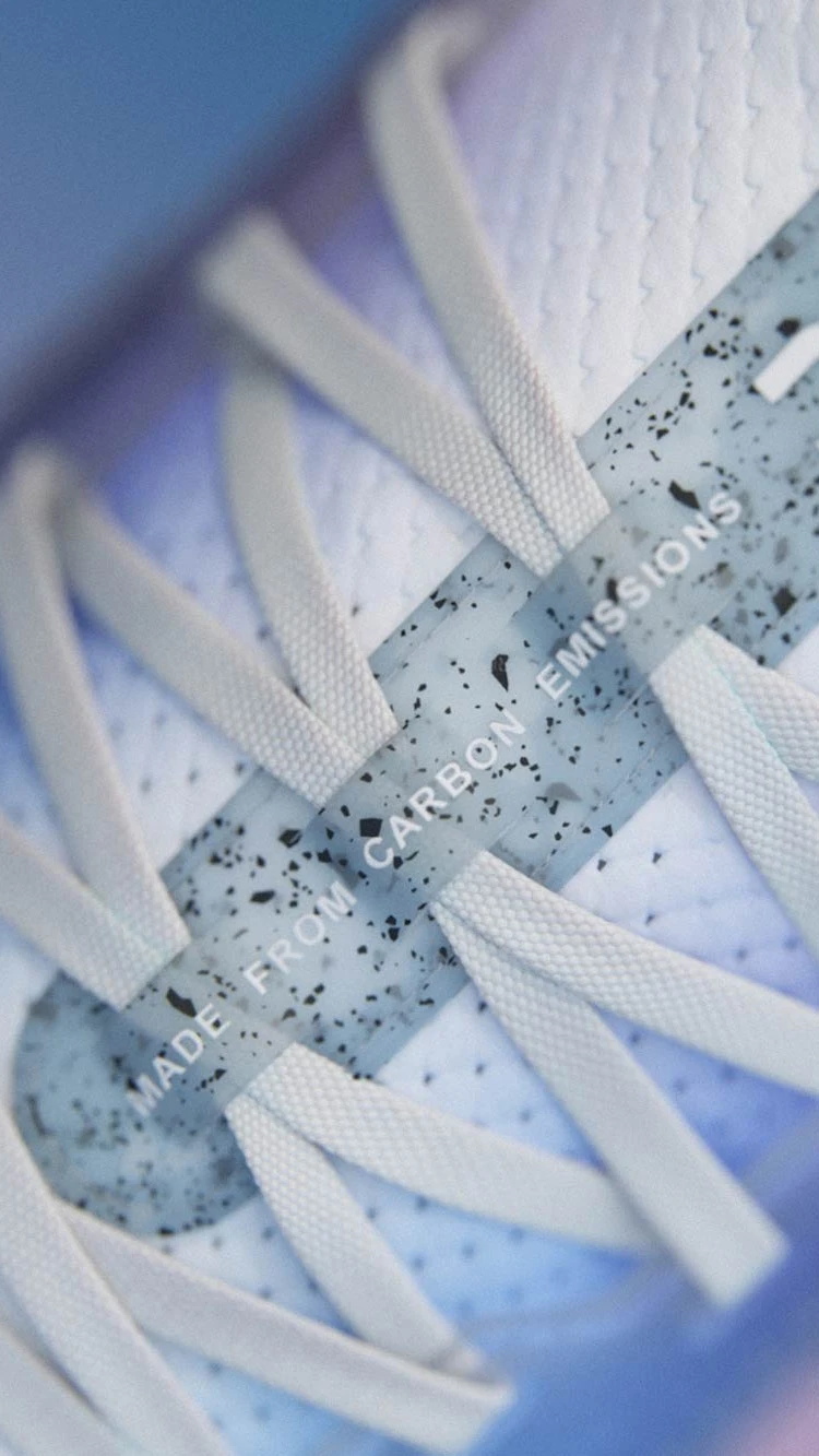 Close-up of the Cloudprime's laces, showing texture and detail. A tag says, Made From Carbon Emissions.