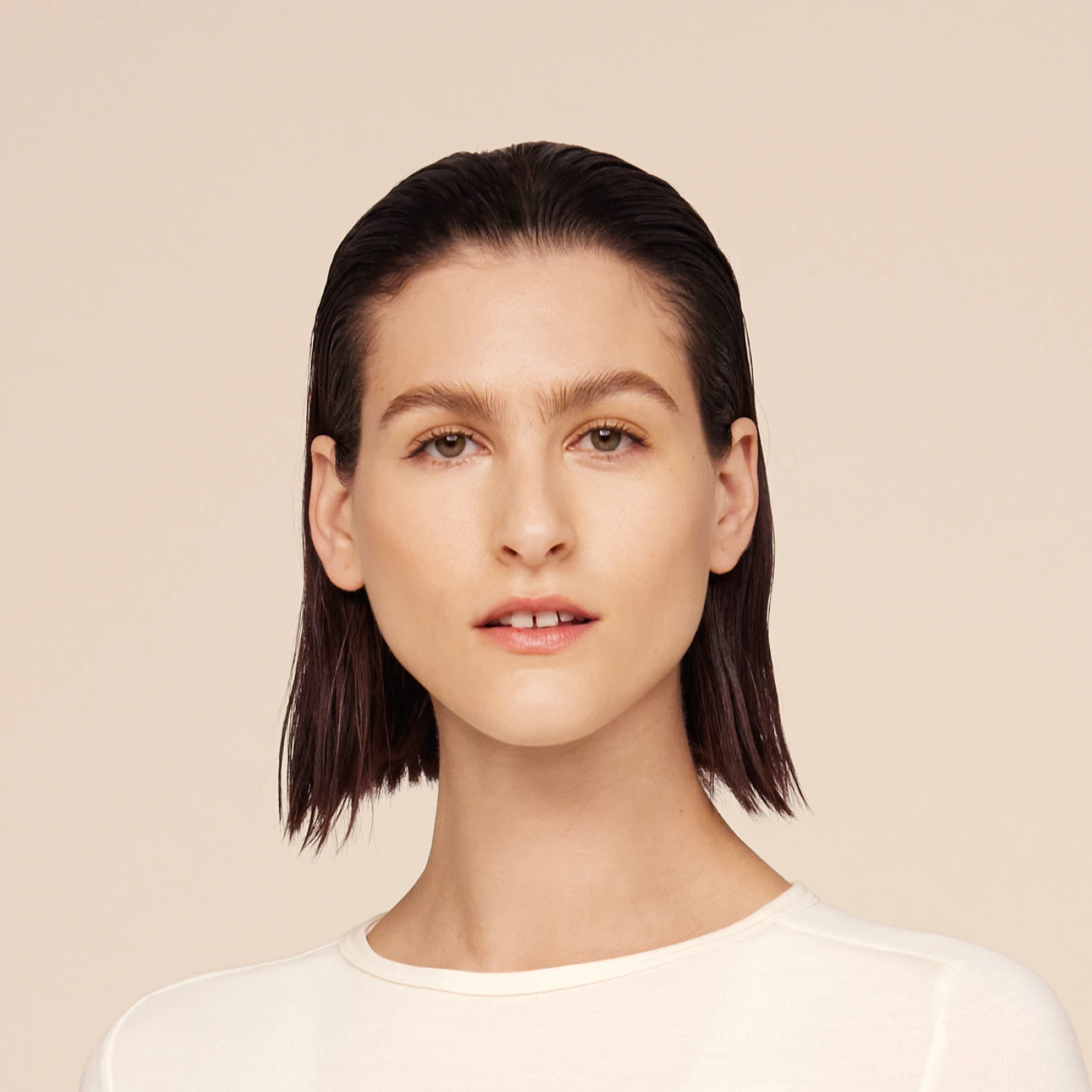 Headshot of Athena, a female model, in a white top.