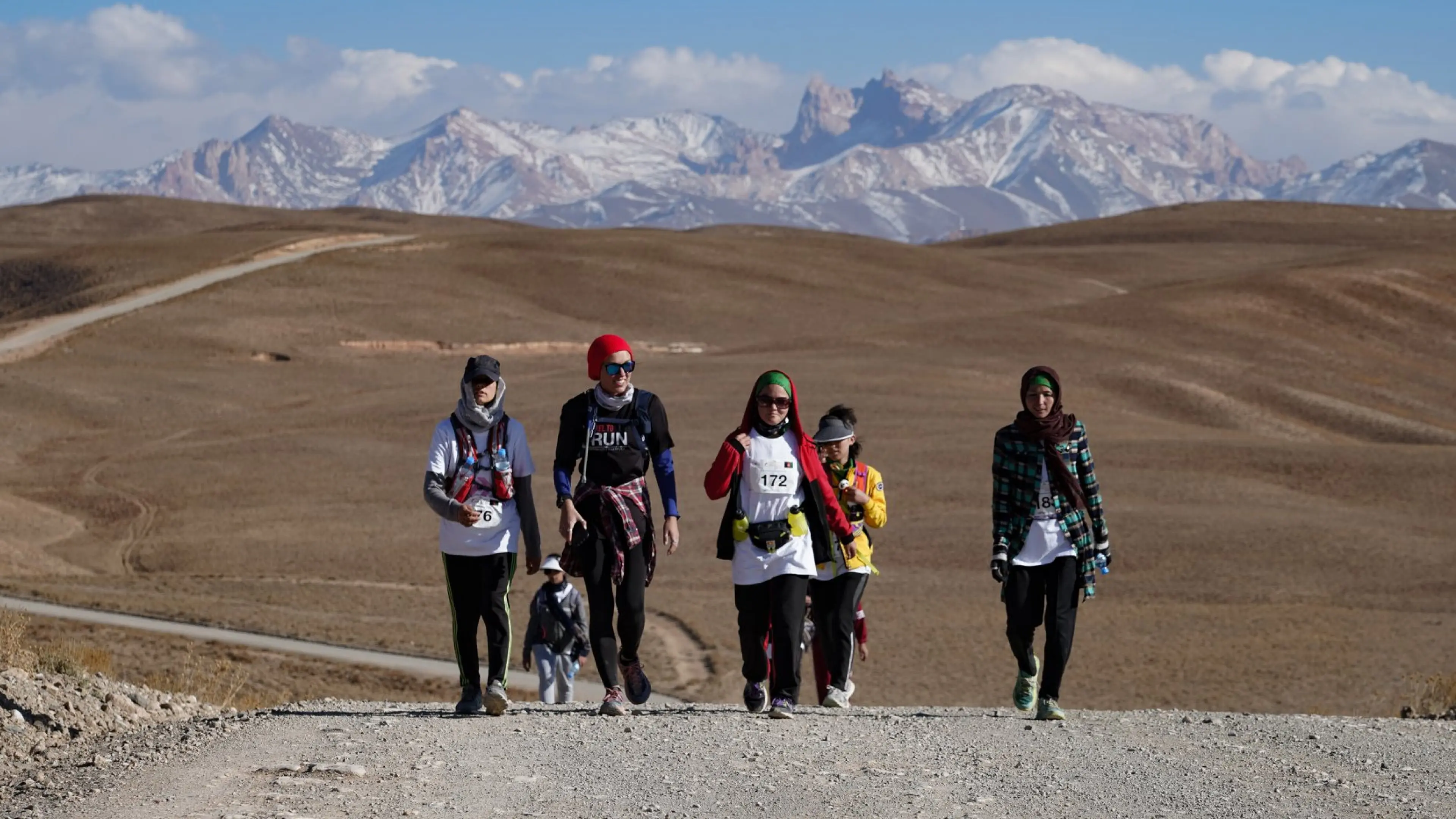 five women walking through the afghan mountains
