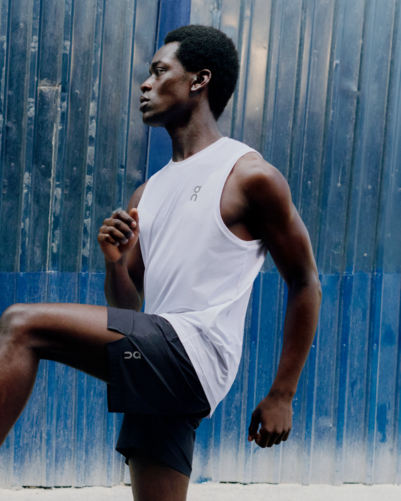 Man performing high knees during a low-impact HIIT workout.