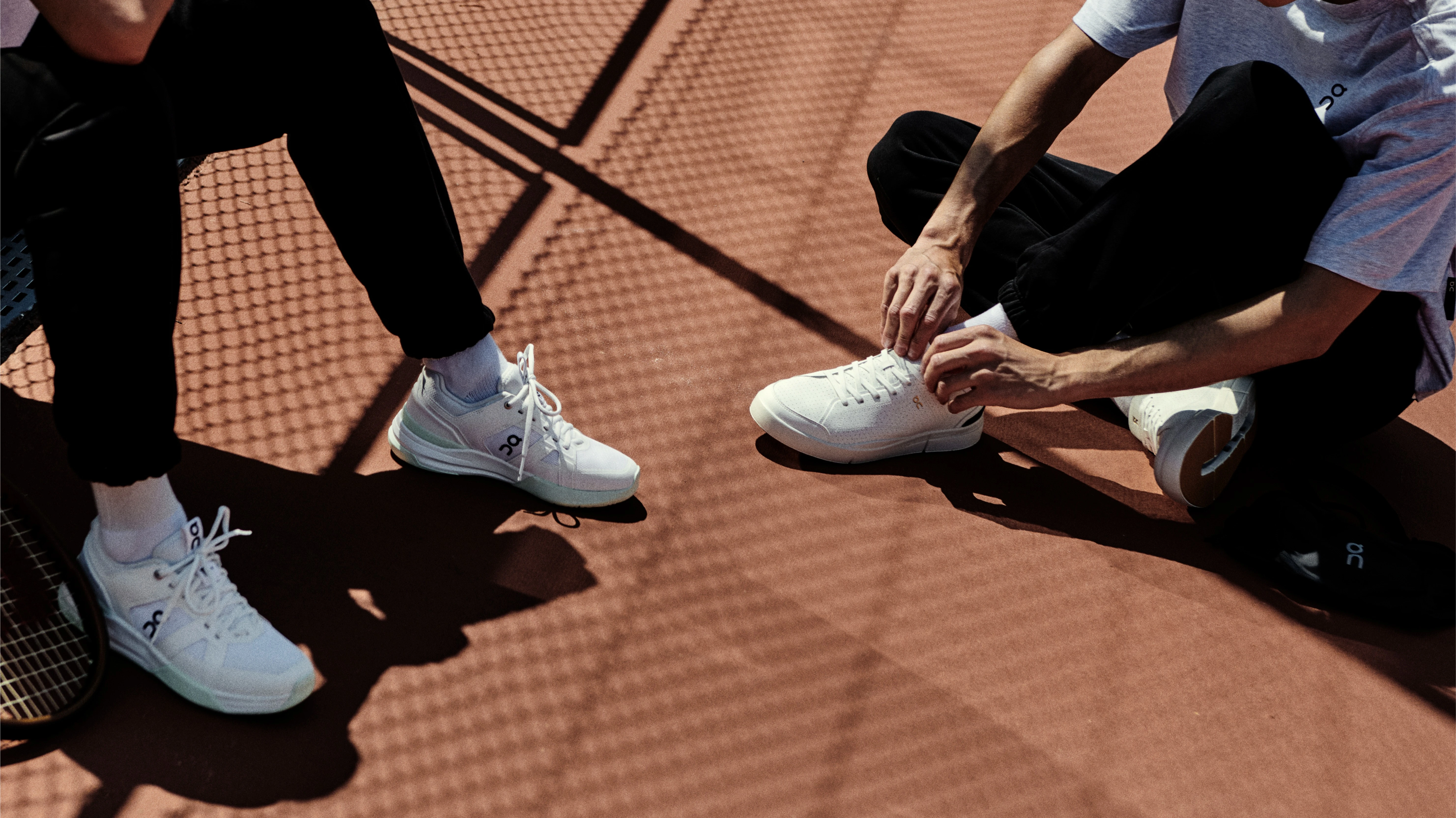 A man takes off his shoes so he can prepare them for washing.