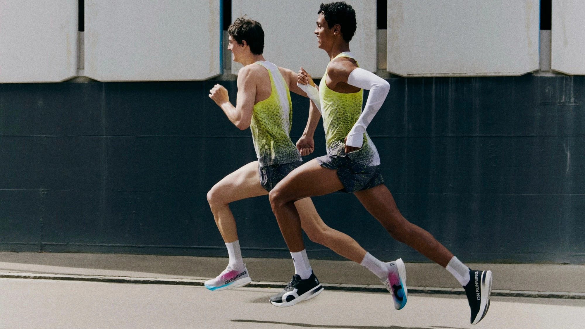 Two runners racing on the road.