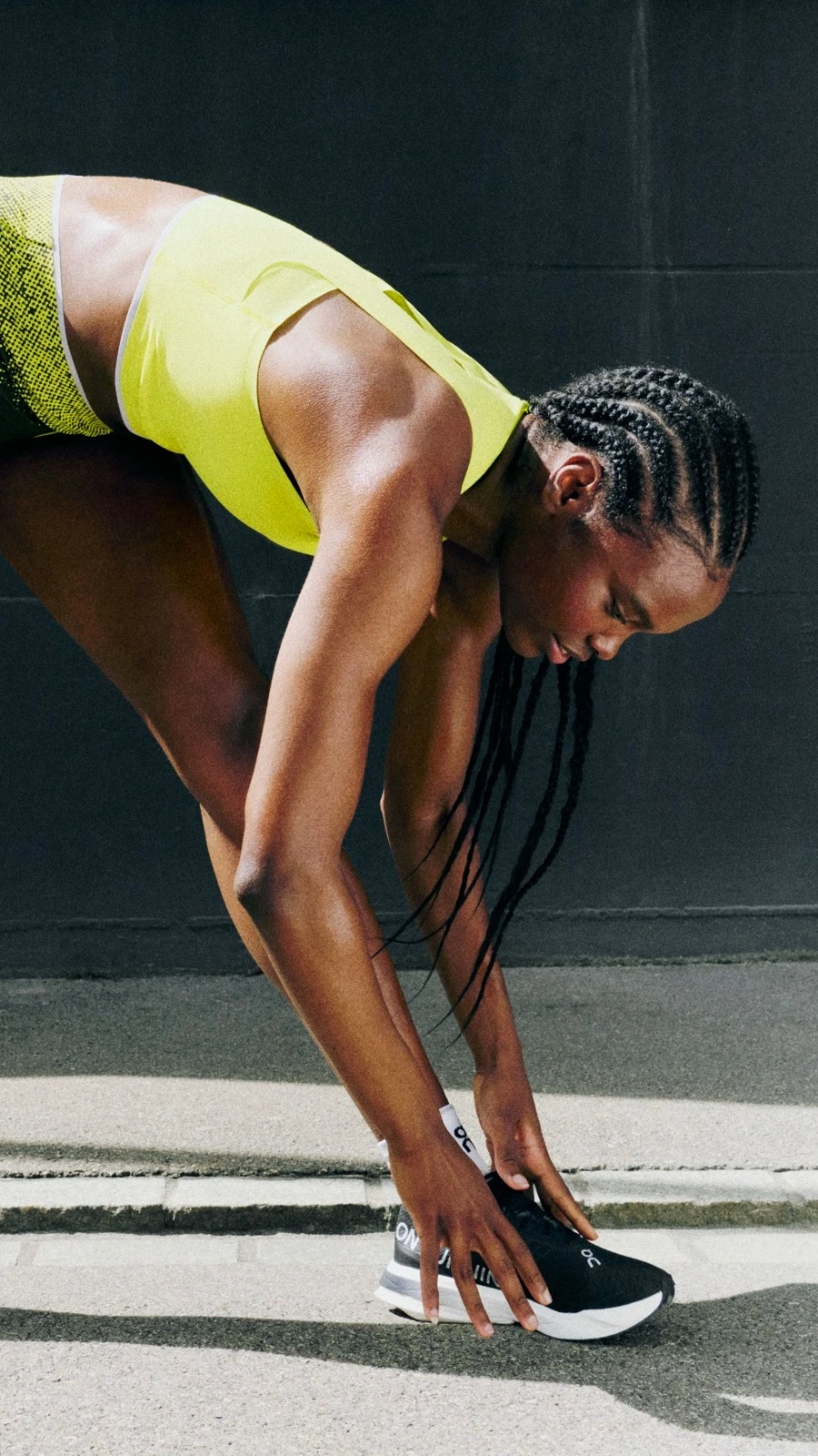 A woman bent over one leg, touching her toes.