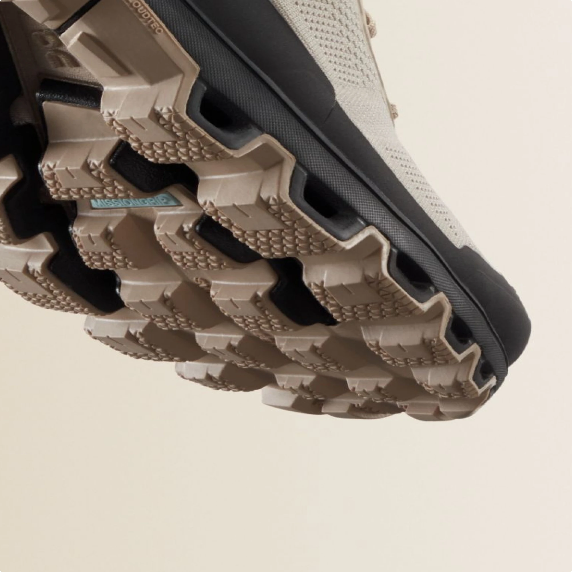 Front of a Missiongrip outsole in brown, floating against a beige backdrop.