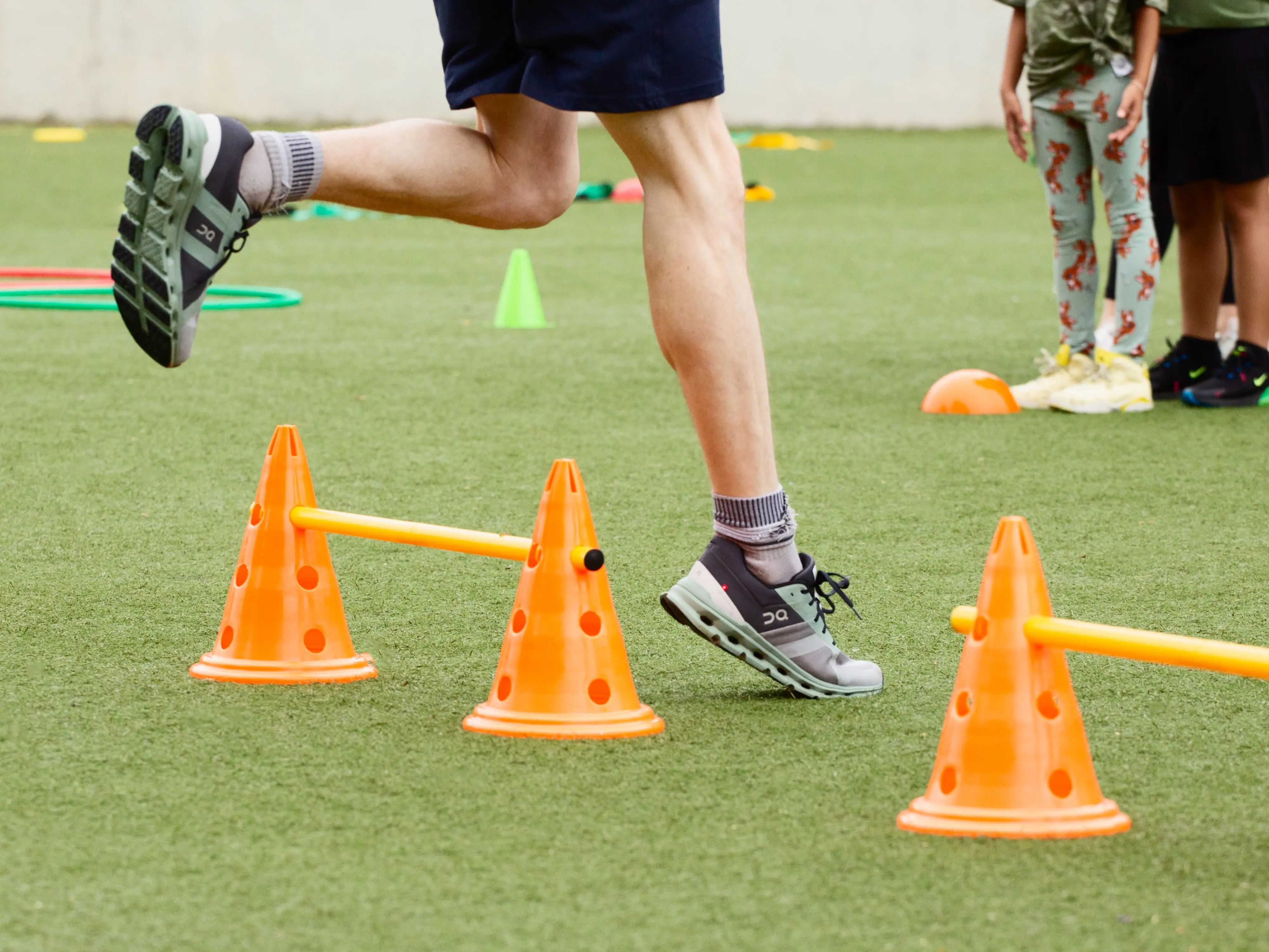 closeup of persons wearing on shoes in agility course