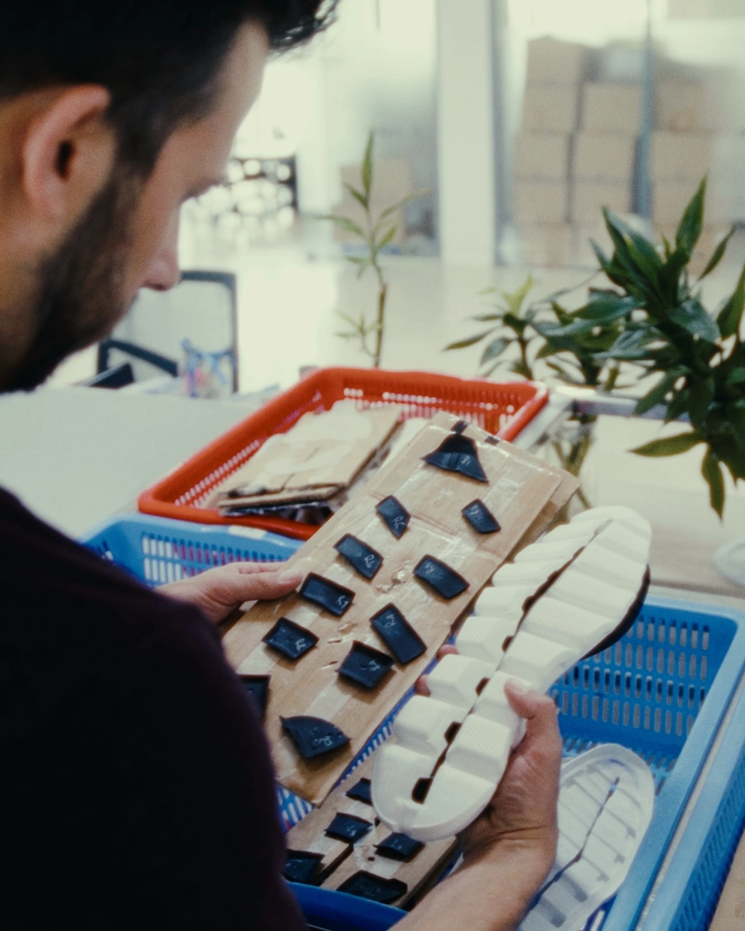 Man checking the details of the Cloudprime's outsole, in the lab.