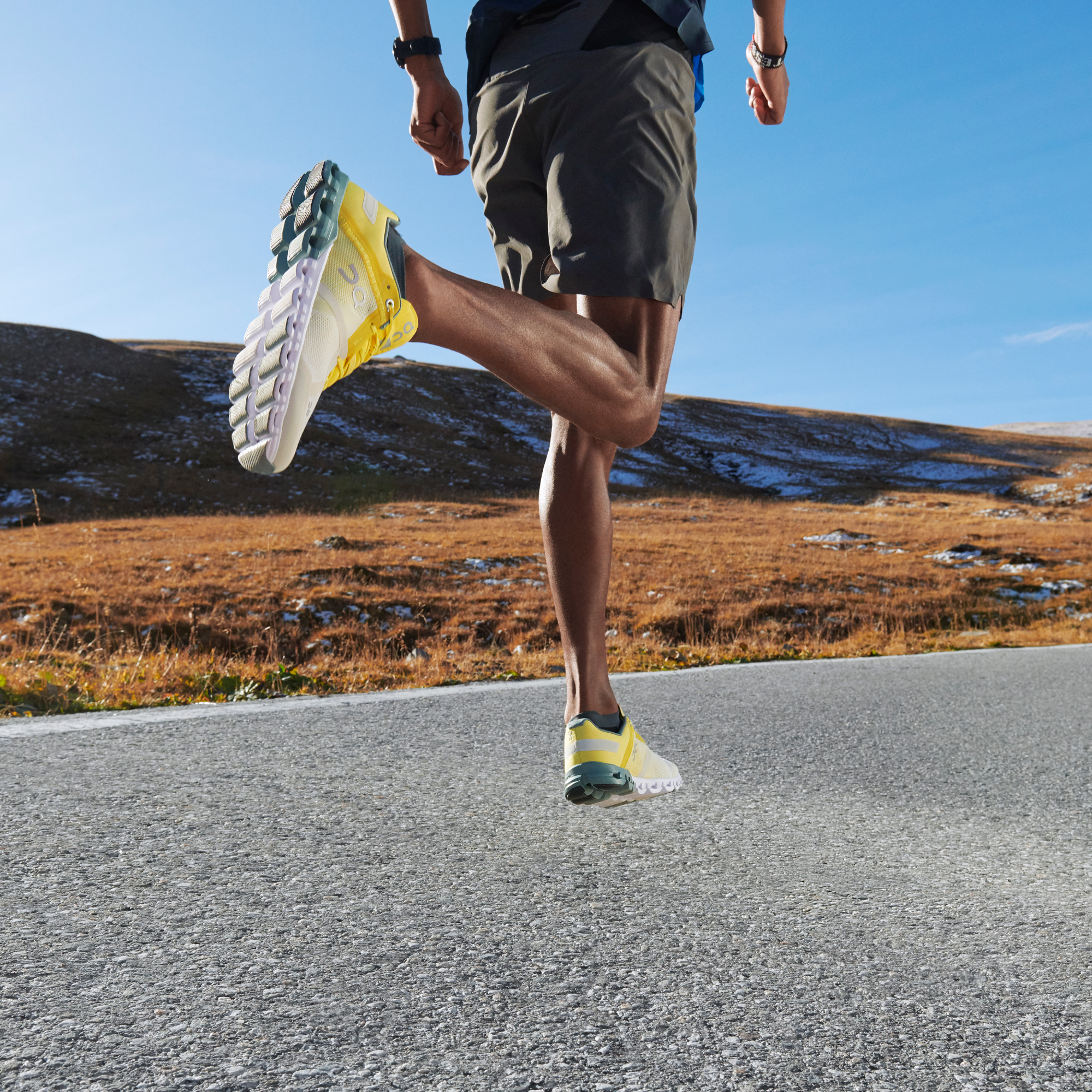 A runner mid stride on a road