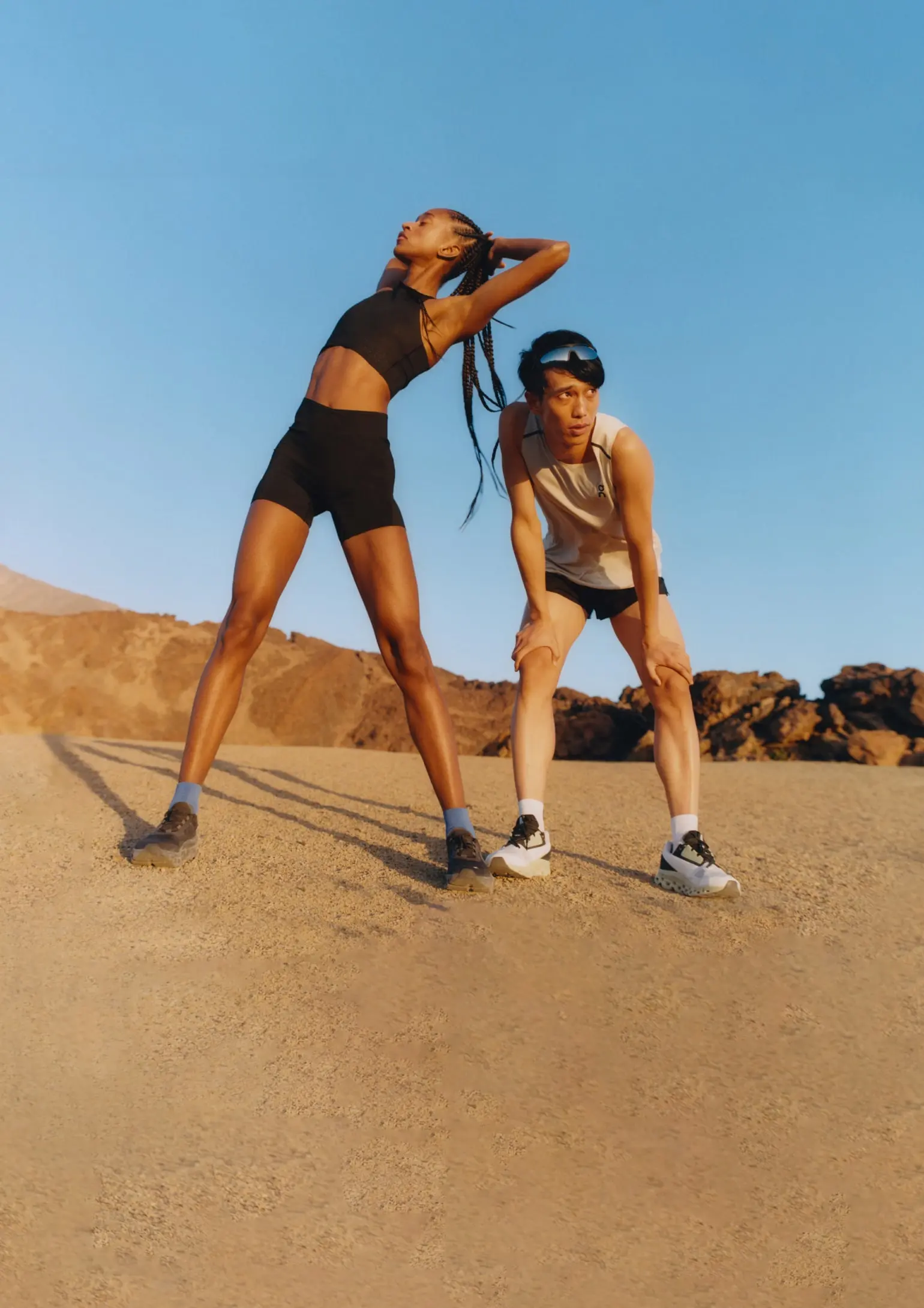 Two runners taking a break on a hard run through the desert.