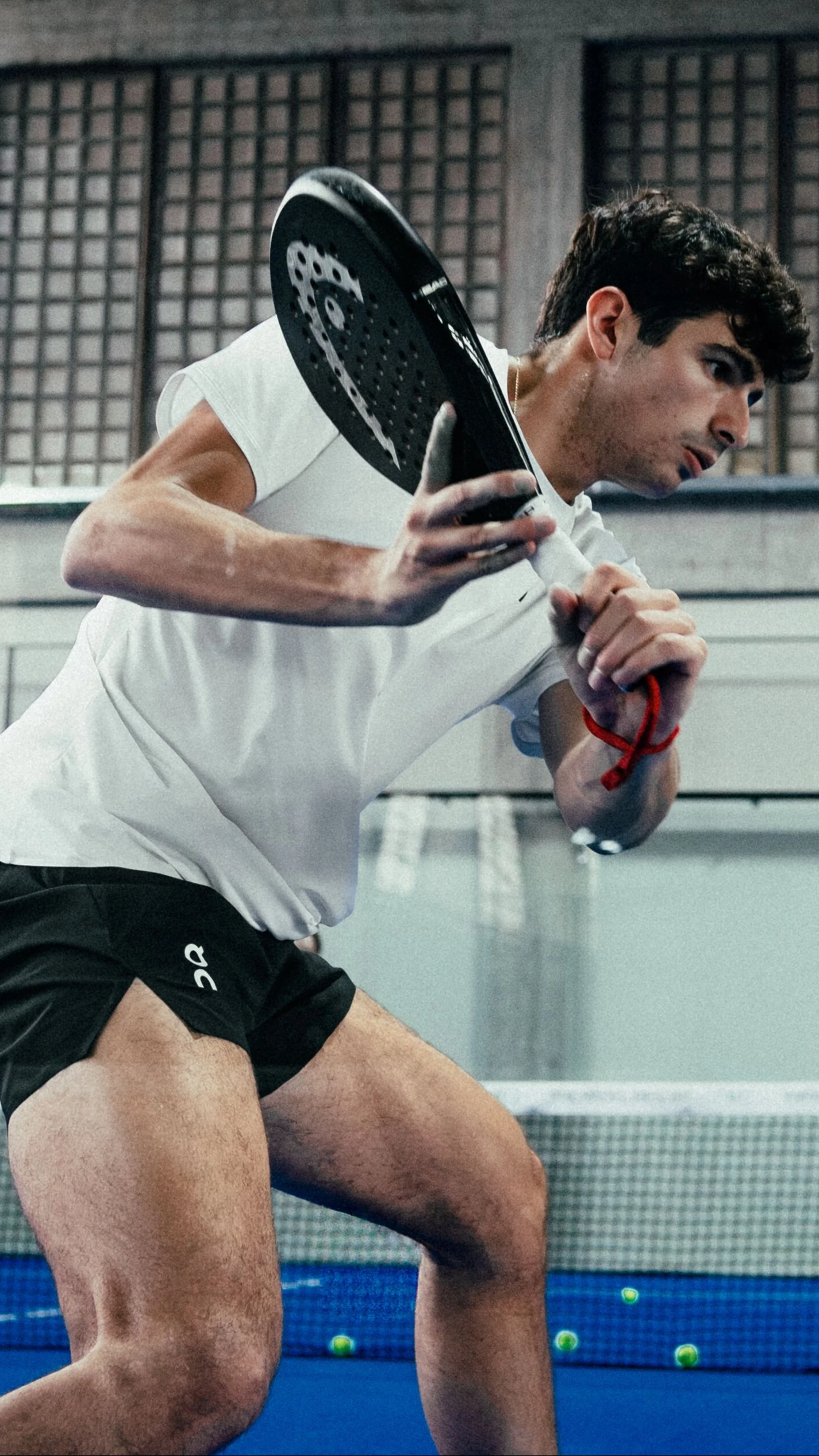 A padel player in On gear swings their padel.